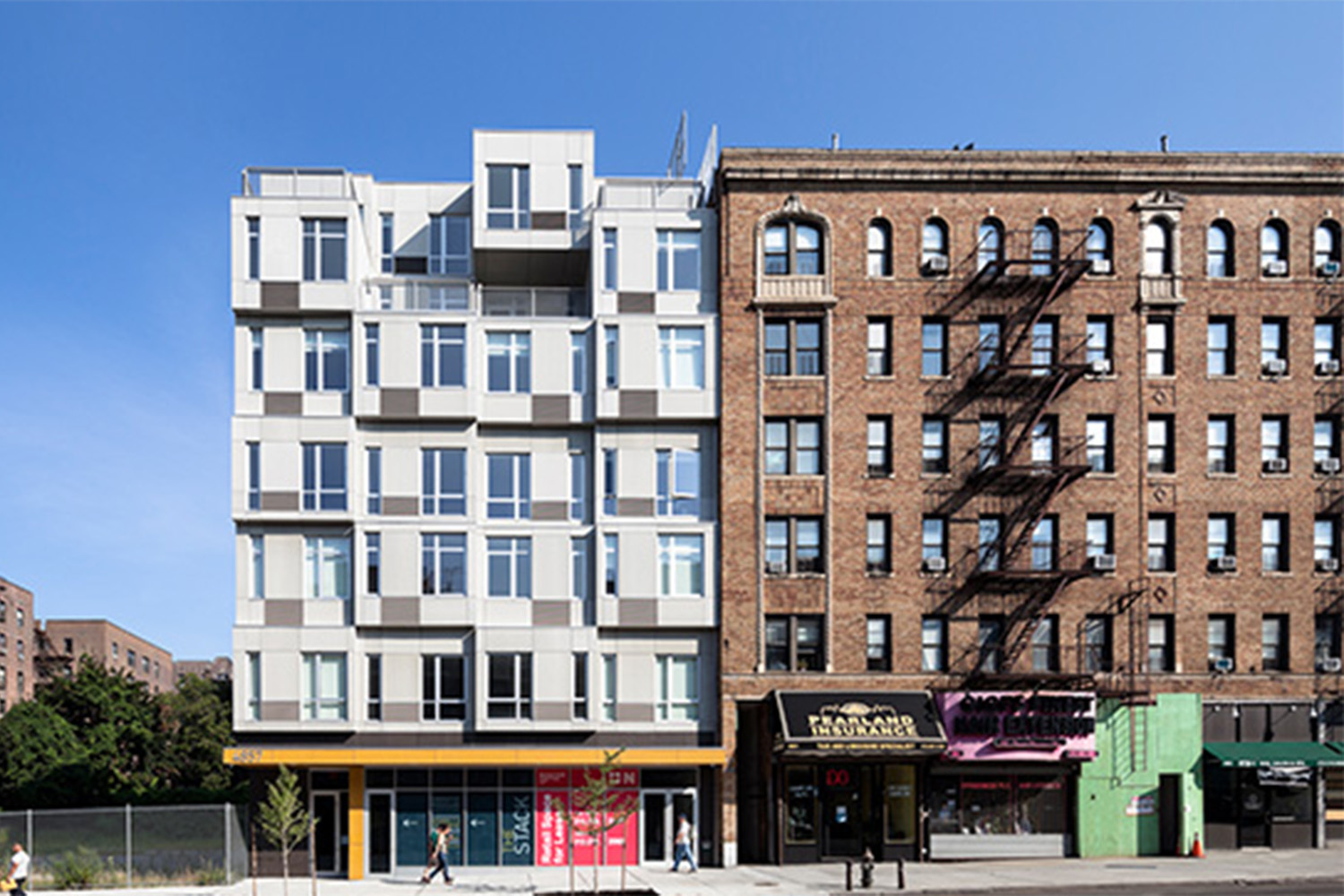 housing in NYC, half brick, half white wood 