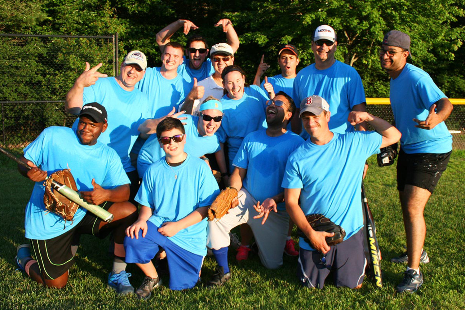 Tocci employees in matching blue shirts, pose for group photo 