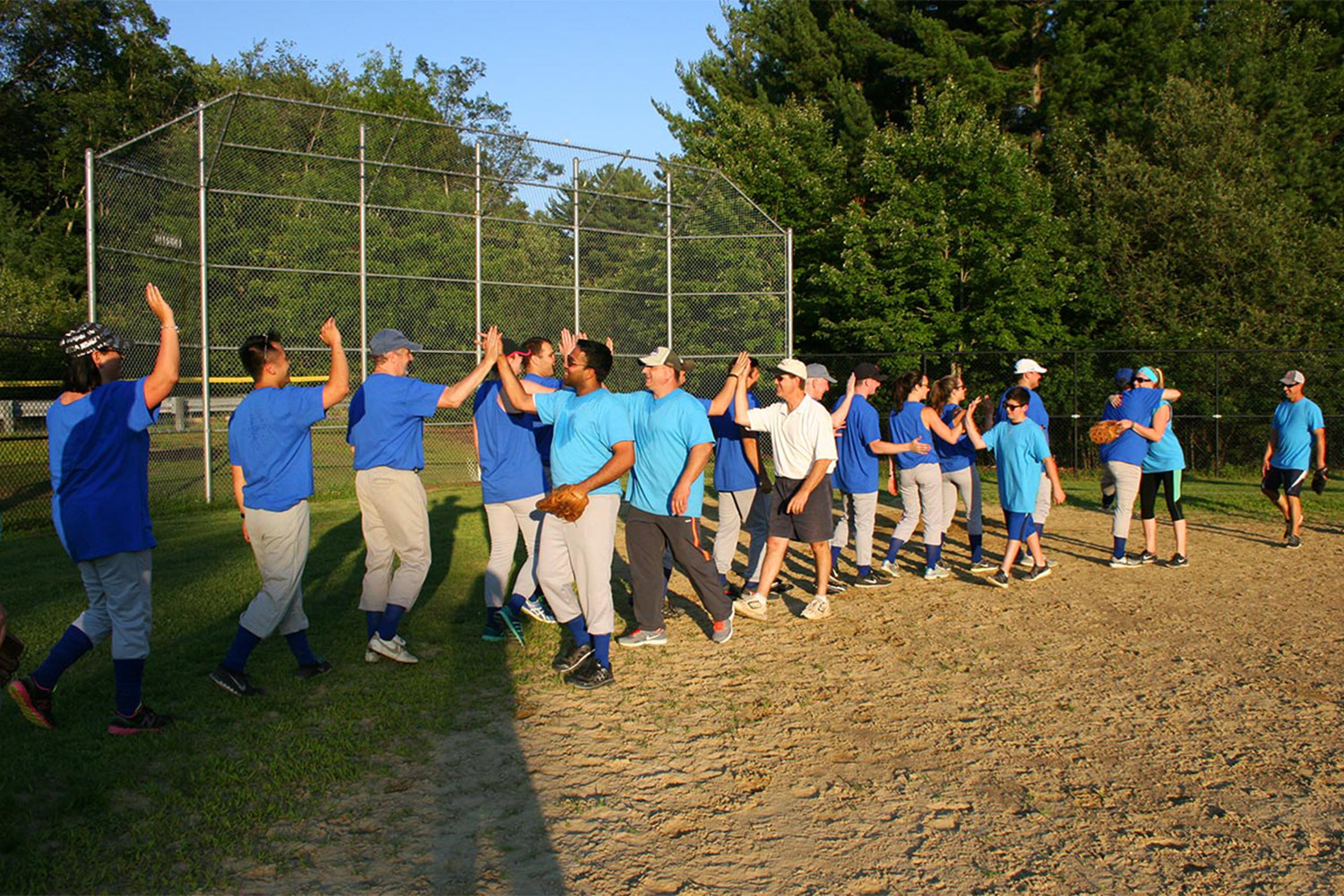 Tocci employees line up to give handshakes after the softball game