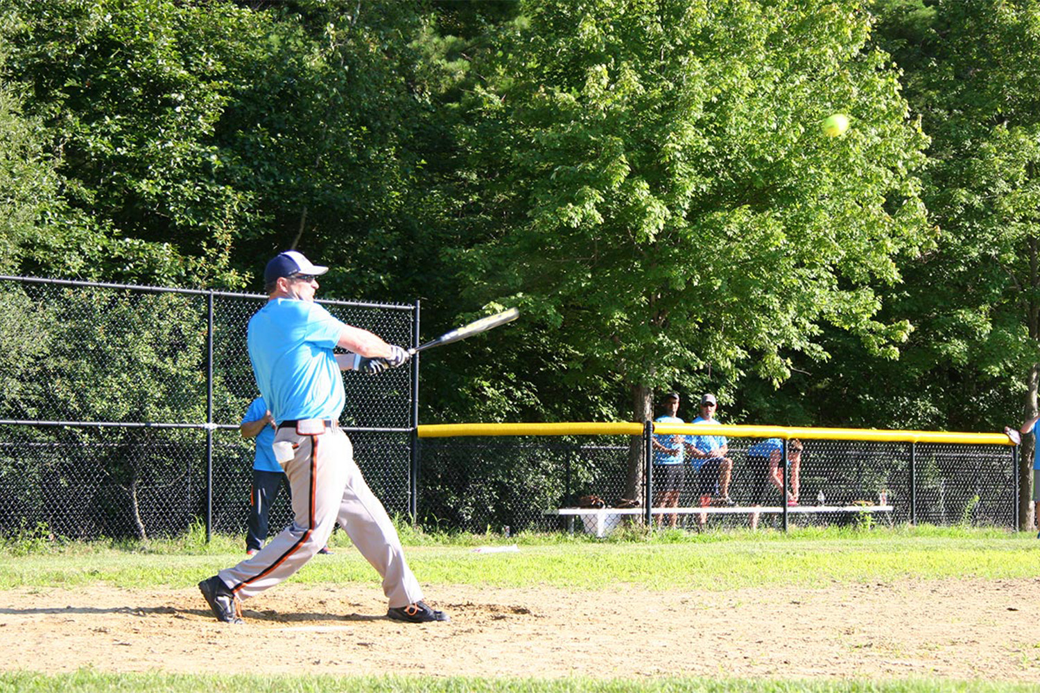 Peter at first base, batting the ball 