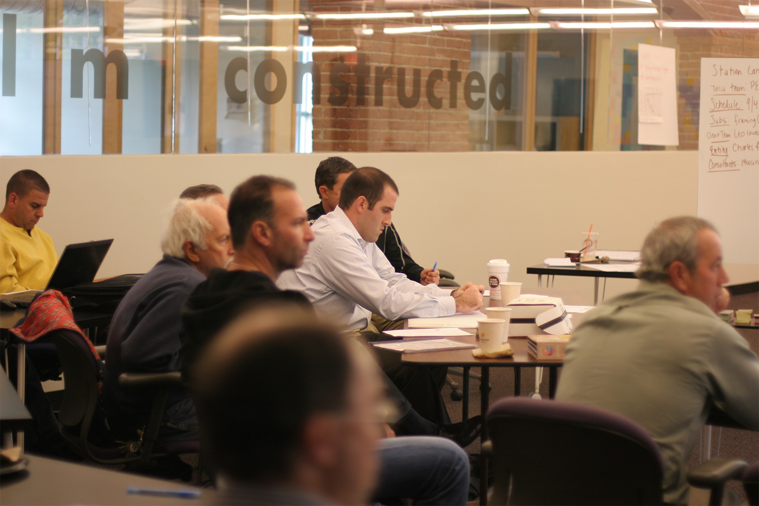 Tocci employees listening in on presentation about Station Landing apartment buildings