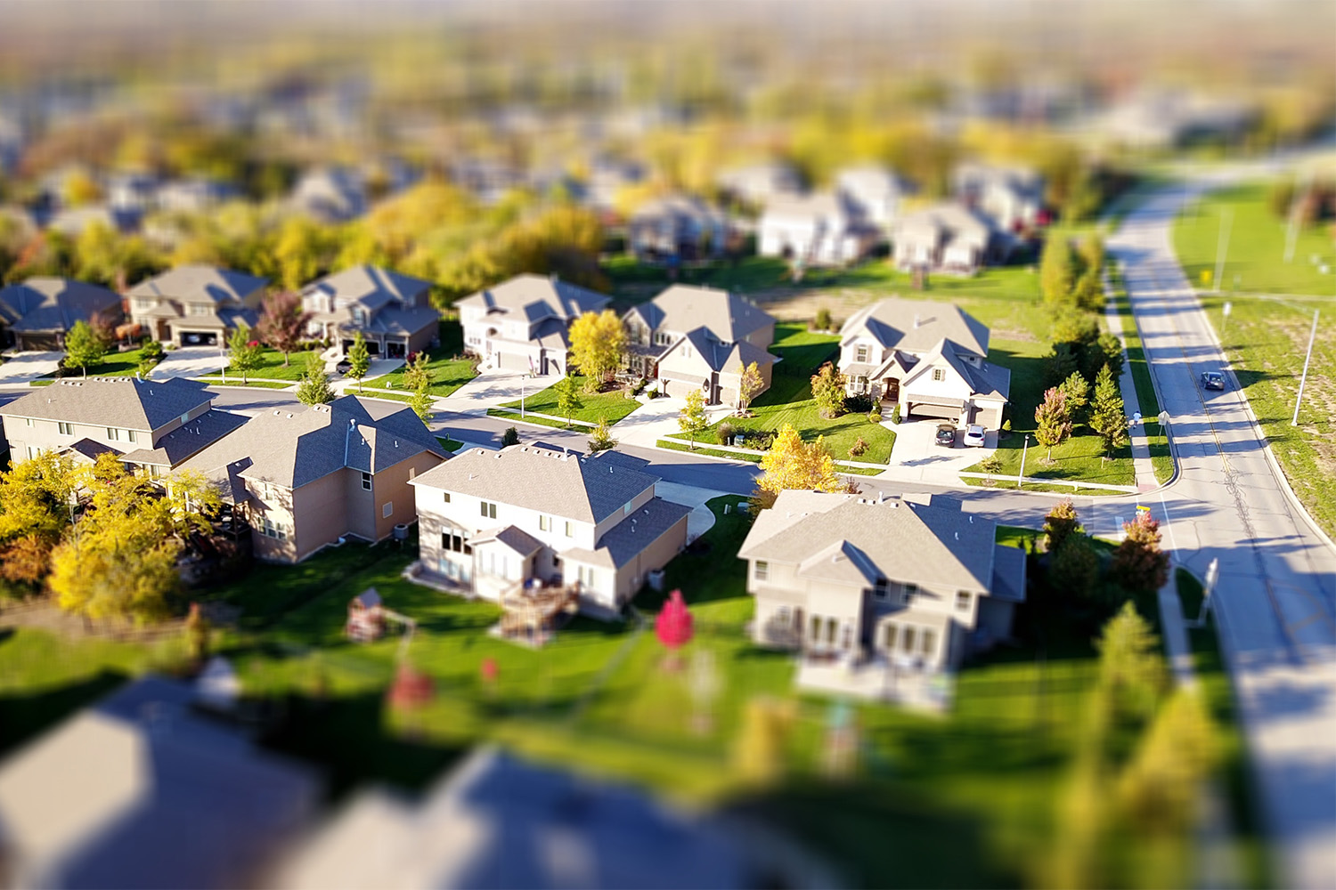 An aerial view of a suburban area, with blurred view on top and bottom