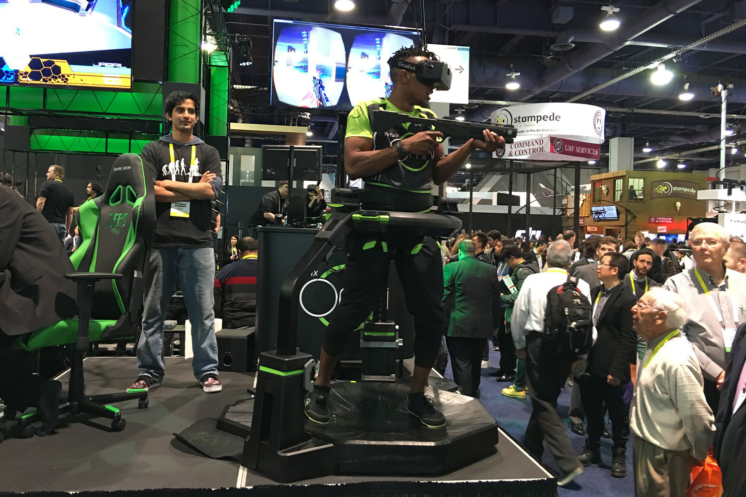 a man using a Virtuix Omni device at tech convention 