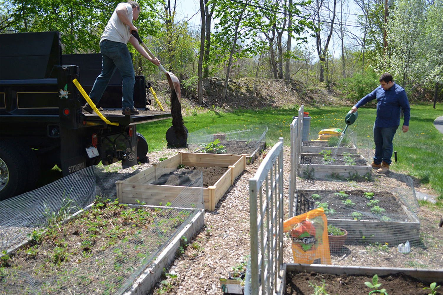 Tocci employees put in the newest garden bed. 