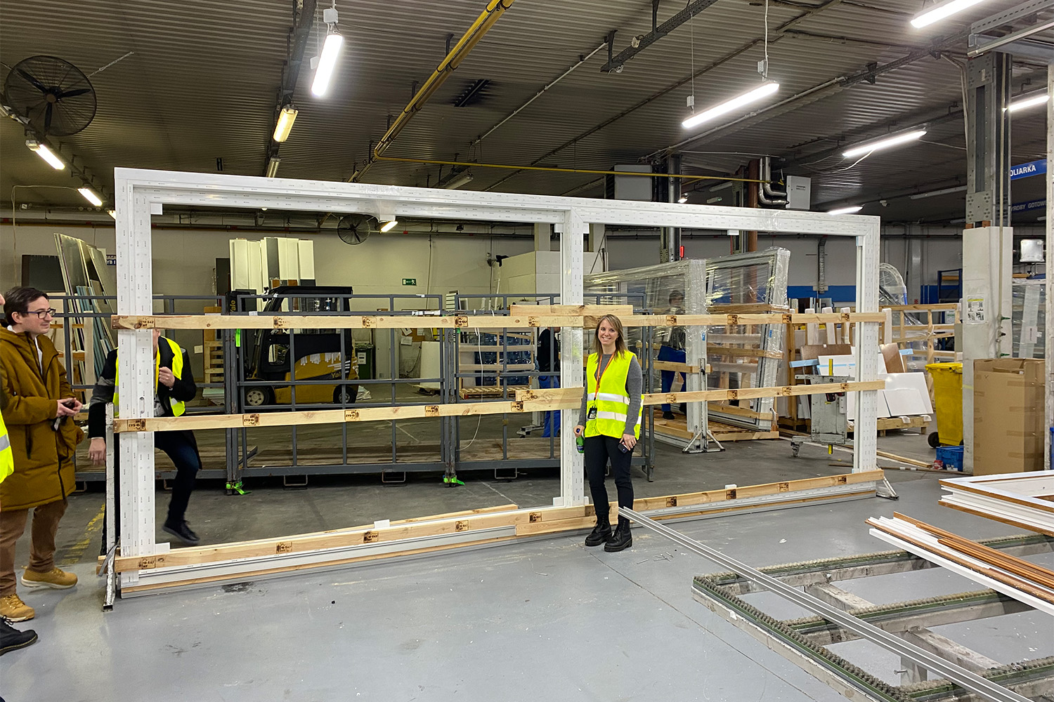 female Tocci employee posing for photo in front of steel beams