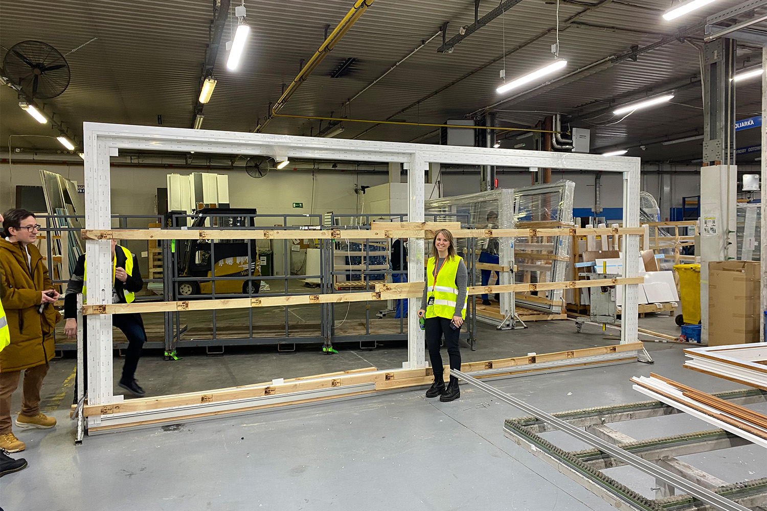 female Tocci employee posing for photo in front of steel beams 