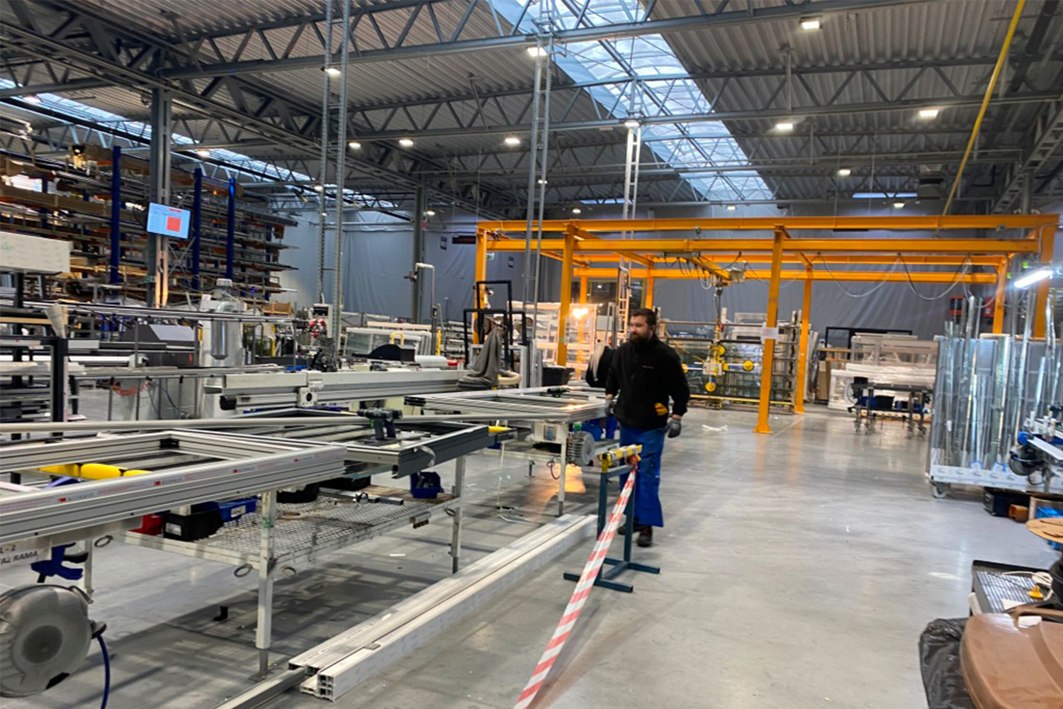 Oknoplast workers walks across factory floor