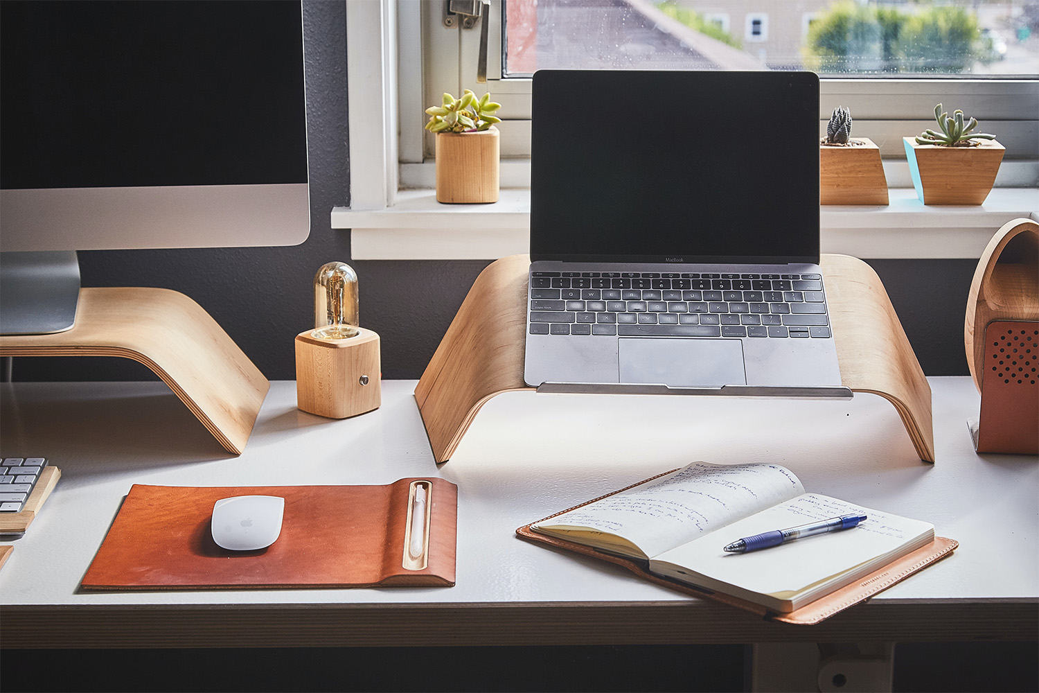 clean and organized desk beside window sill 