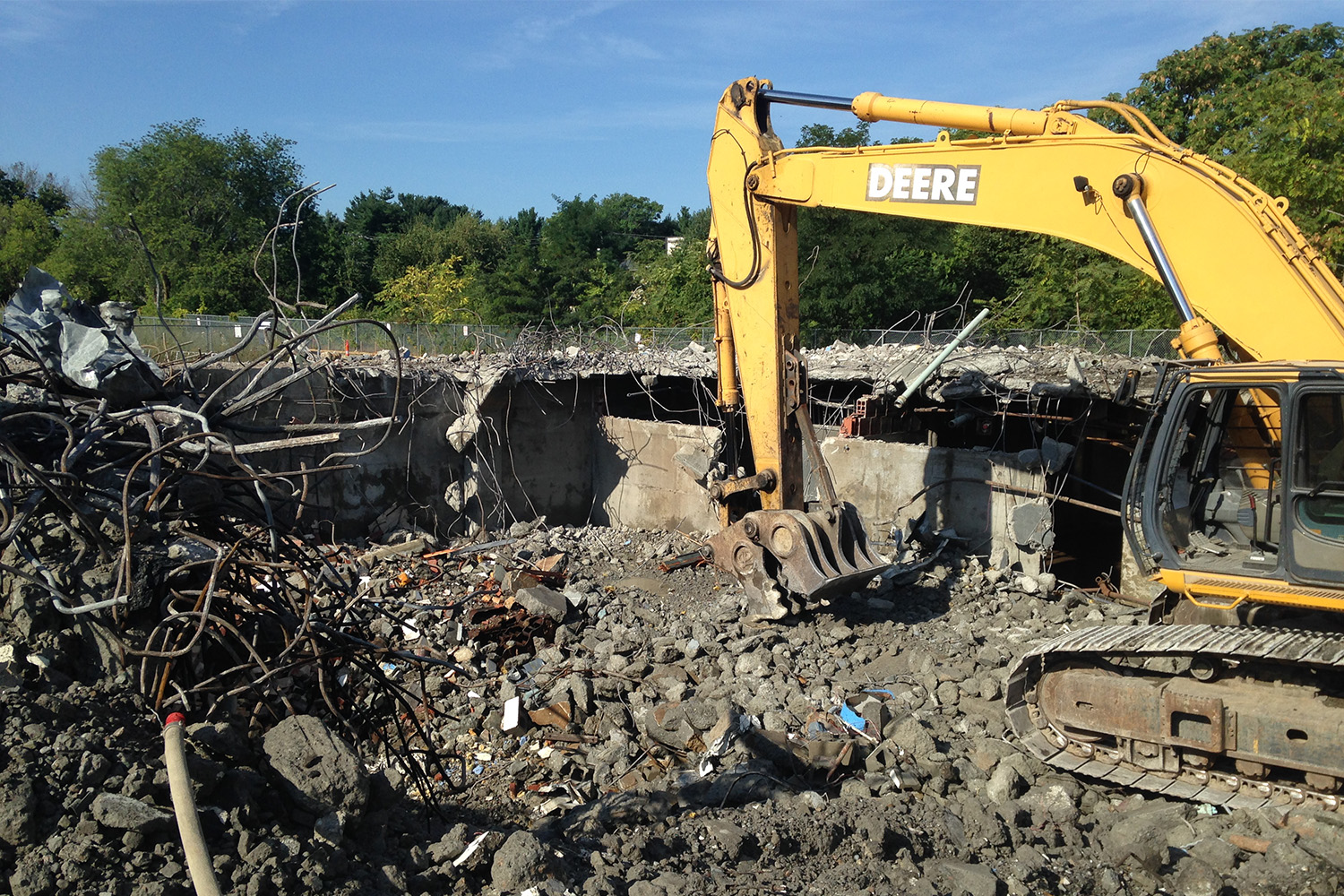 a bulldozer in the middle of rocks and rubble 