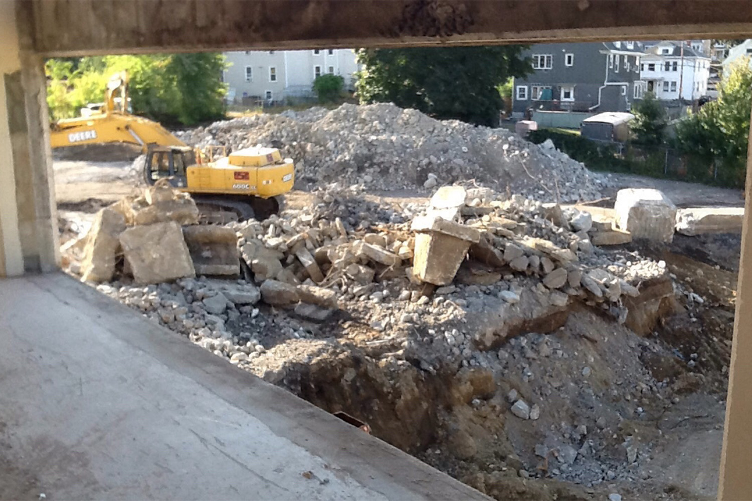 view from under roof, of bulldozer in rubble 