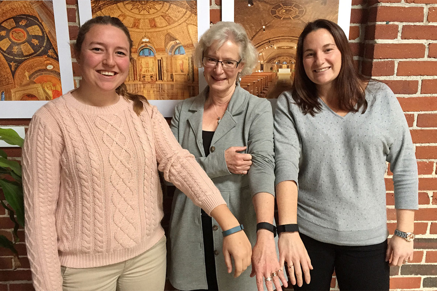 3 Tocci employees wearing FitBit bracelets 