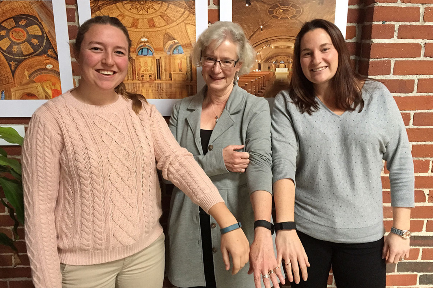 3 Tocci employees wearing FitBit bracelets