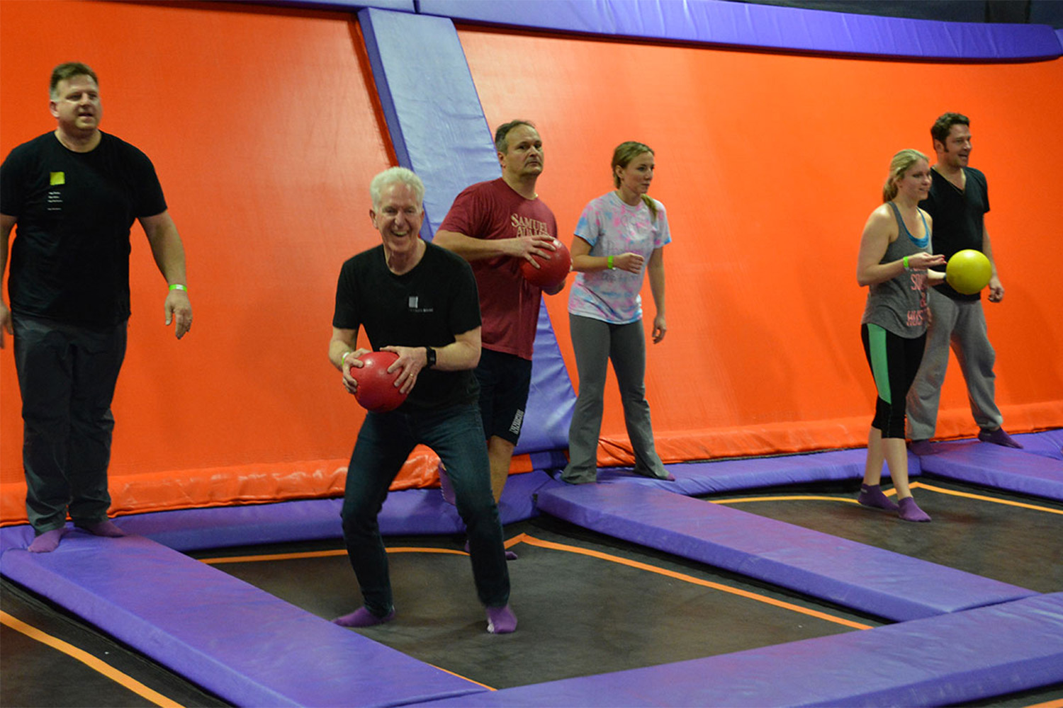Tocci employees playing dodgeball at trampoline park 