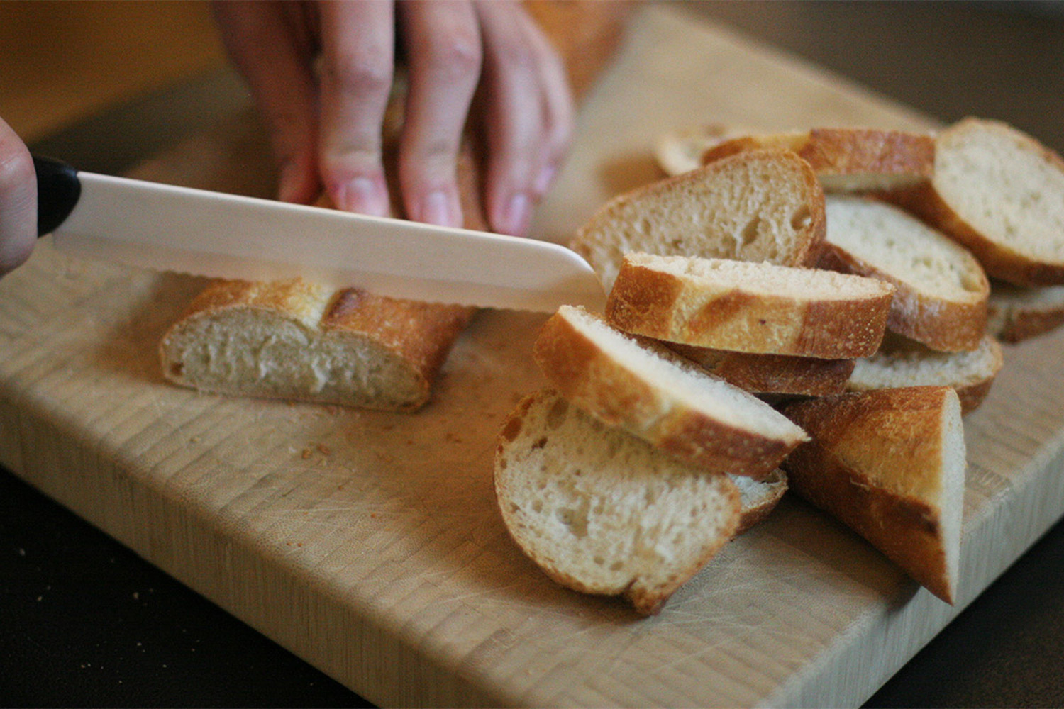 Slicing the baguette for the delicious pesto dip.