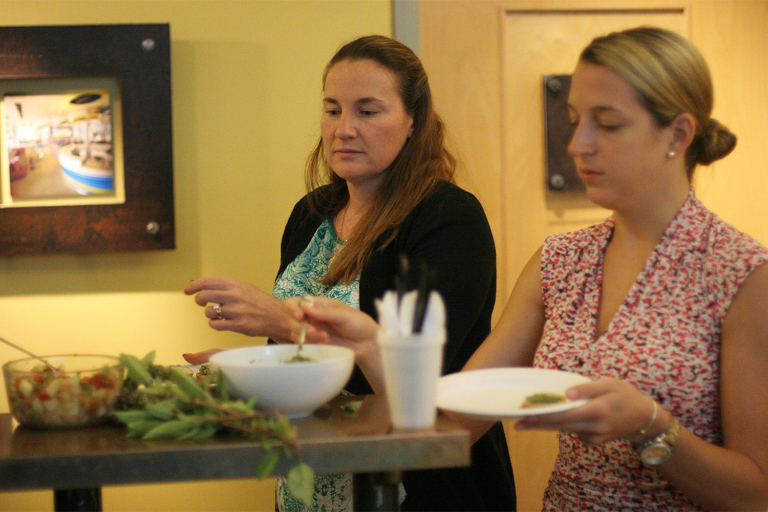 Alli and Tia fill up their plates with some tasty treats.