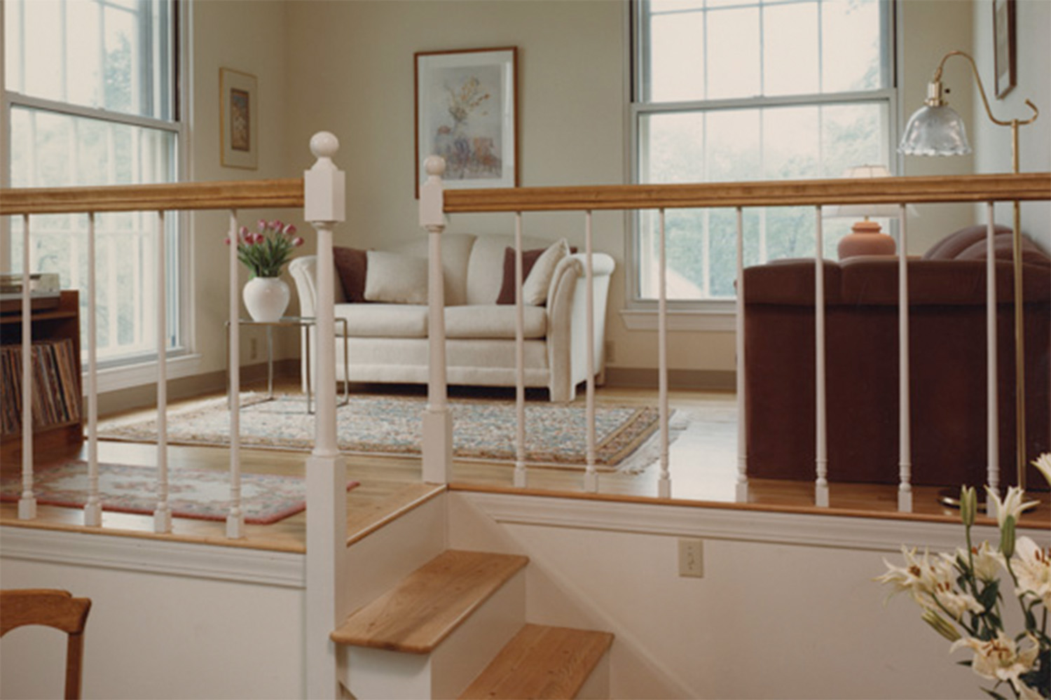 view from walking up stairs, into clean living room 