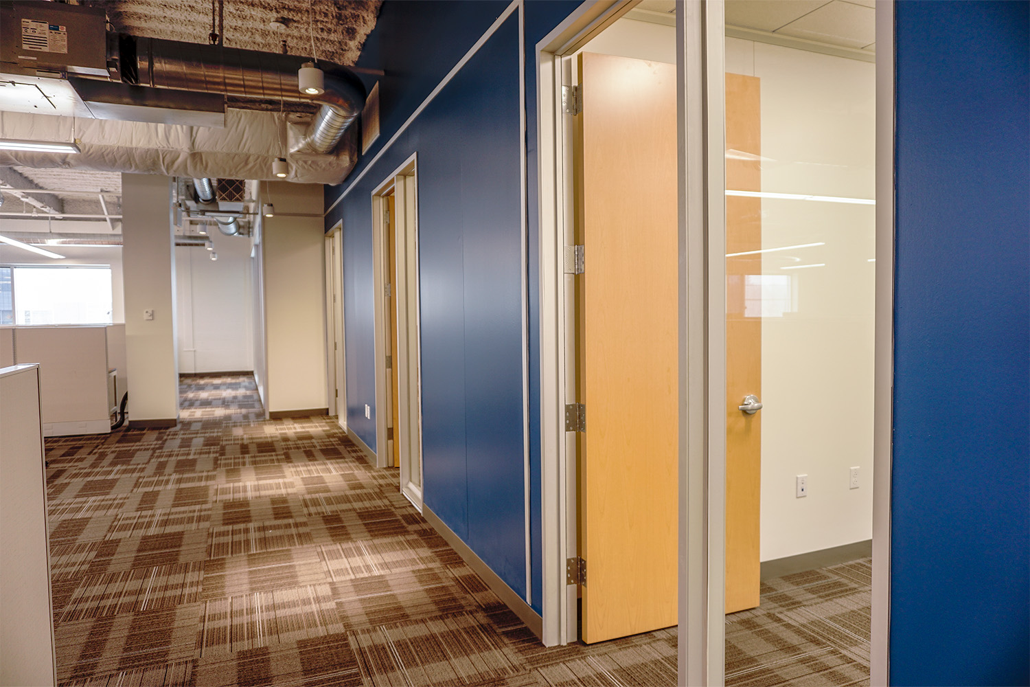 blue-painted hallway with wooden doors