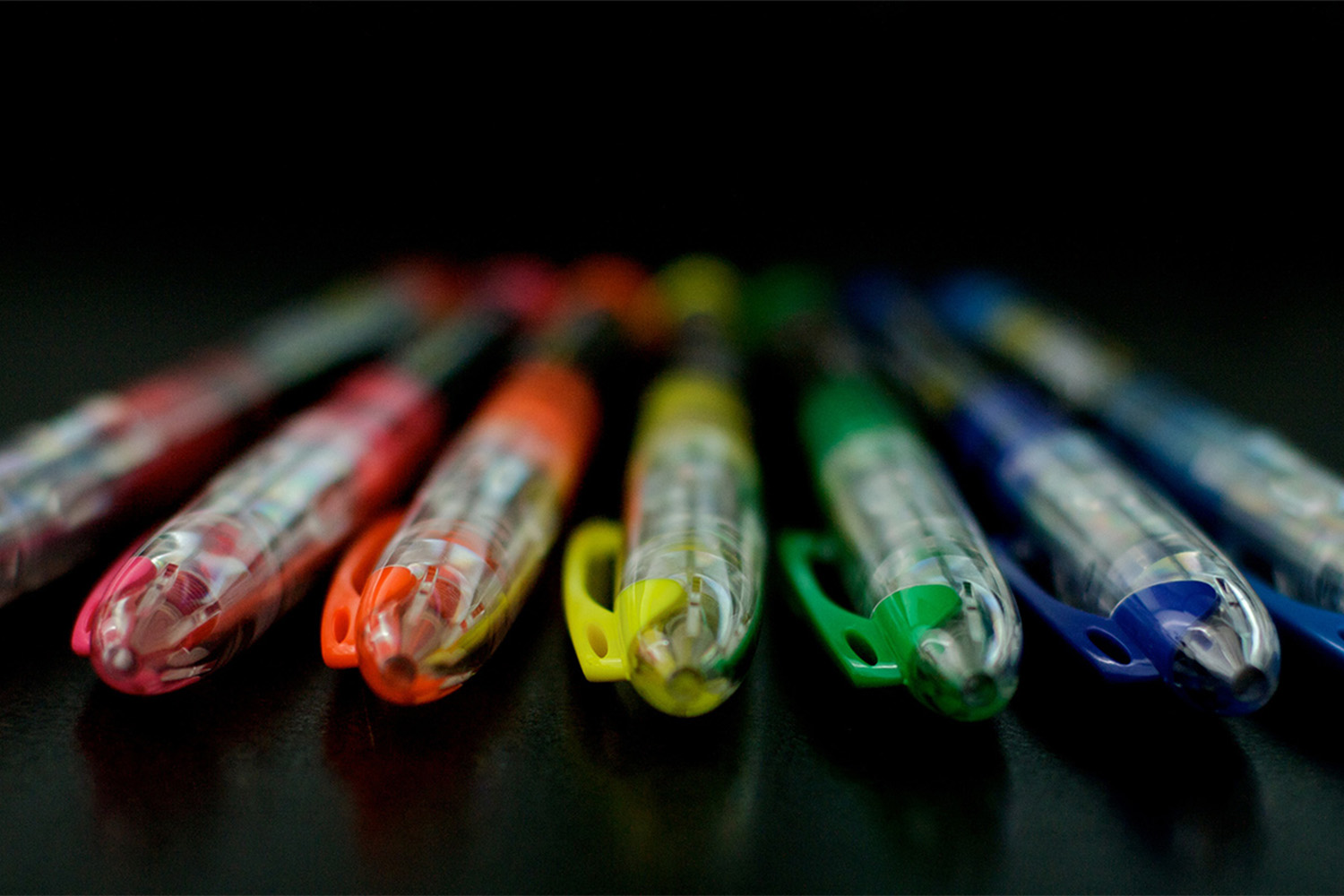 a row of highlighters in the rainbow order 