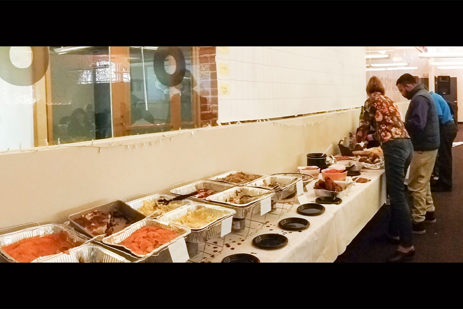 Tocci employees filling their plates with Thanksgiving food 