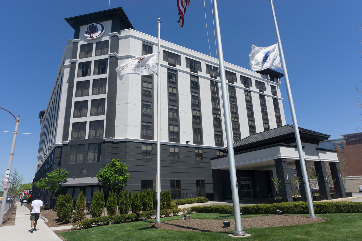 angled corner view of the hotel, with flags out front 