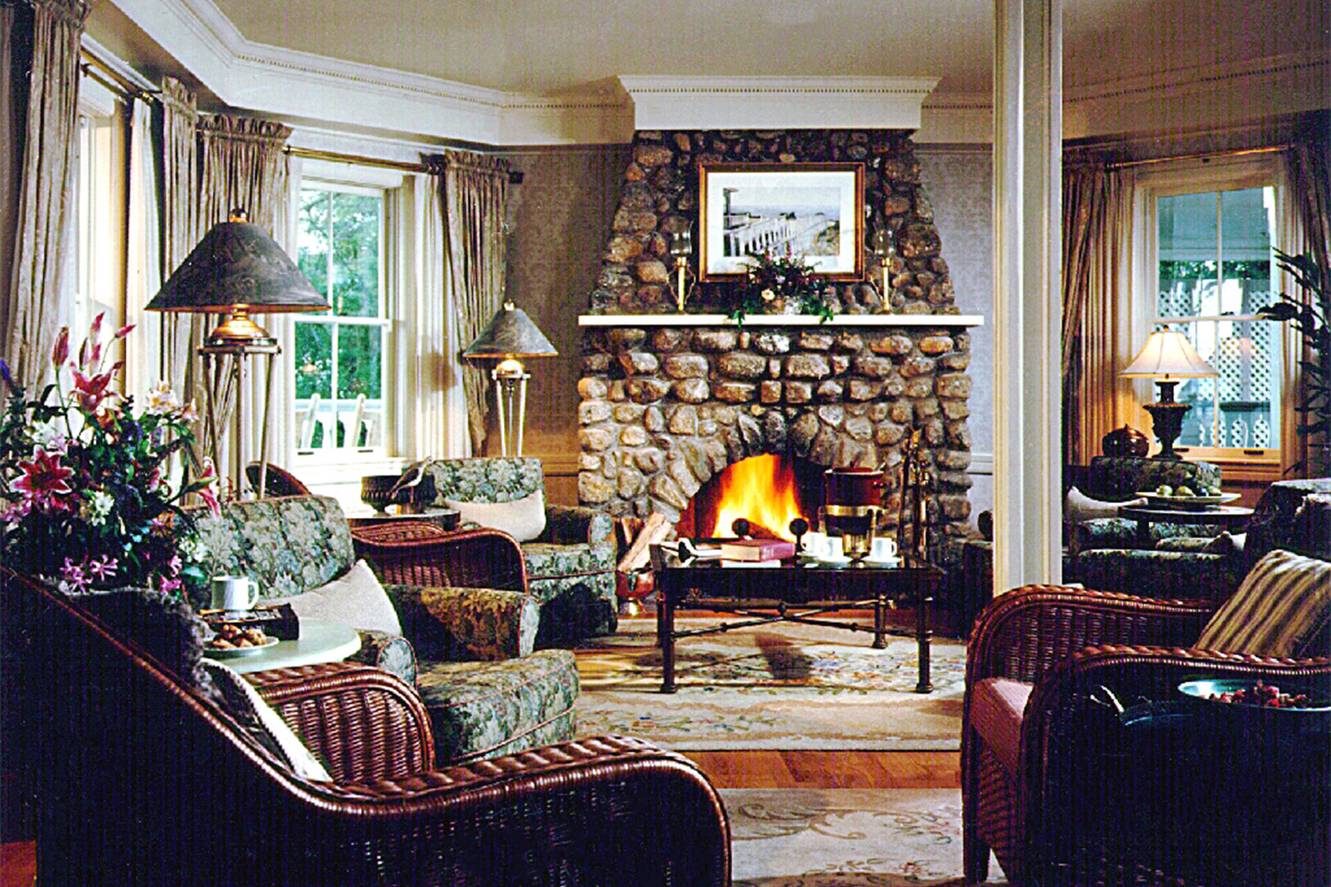 cozy fireplace with burgundy seat spread around the room 
