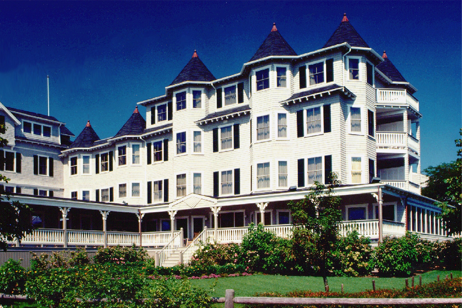 view of the Harbor View Hotel, seen from across lush green lawn 