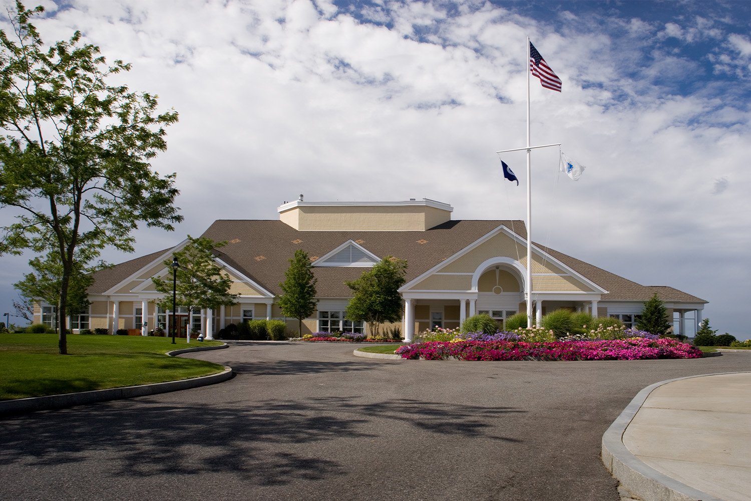 view of the New Seabury Clubhouse seen from across parking lot 