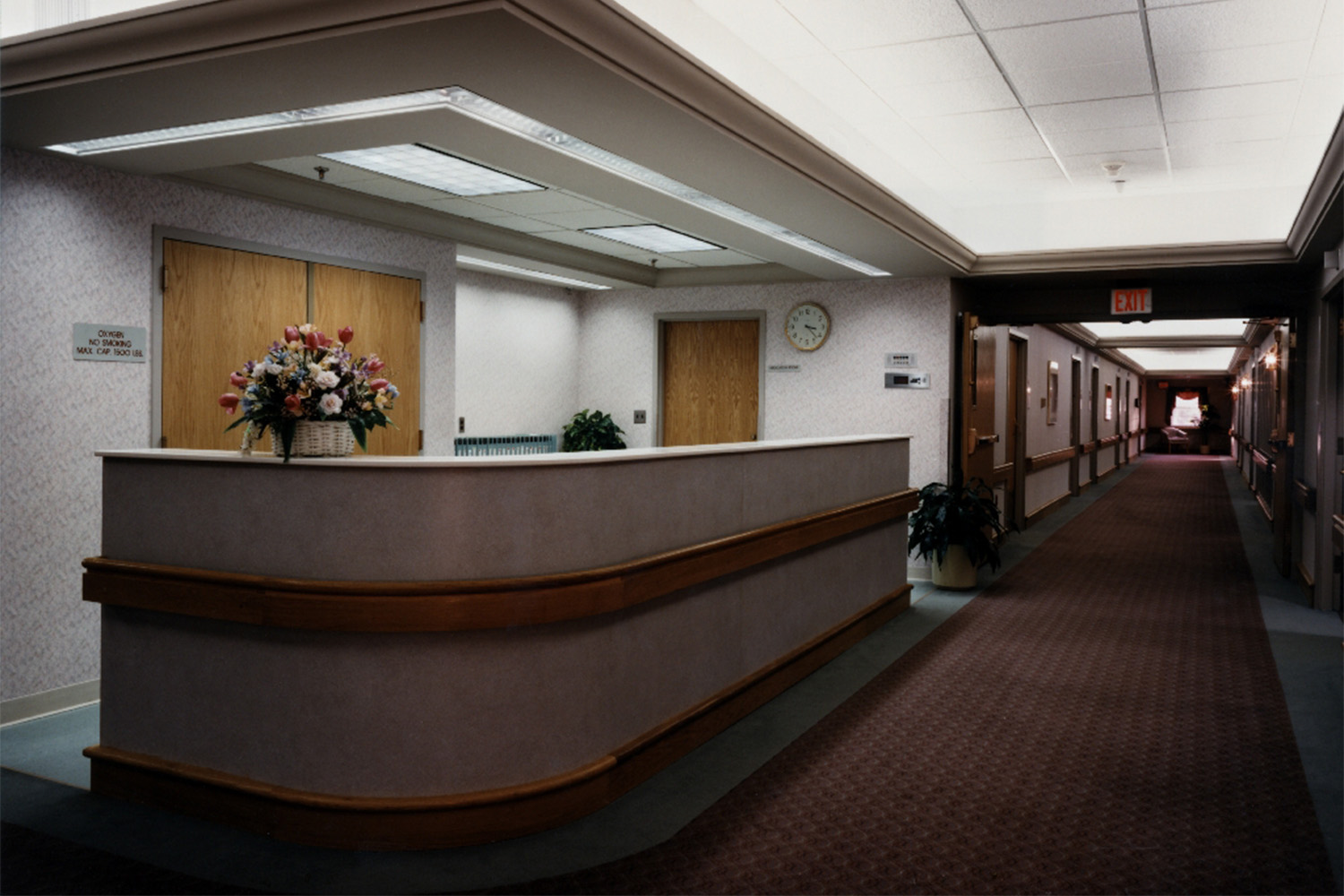 reception desk at care facility, with woman hiding behind desk 