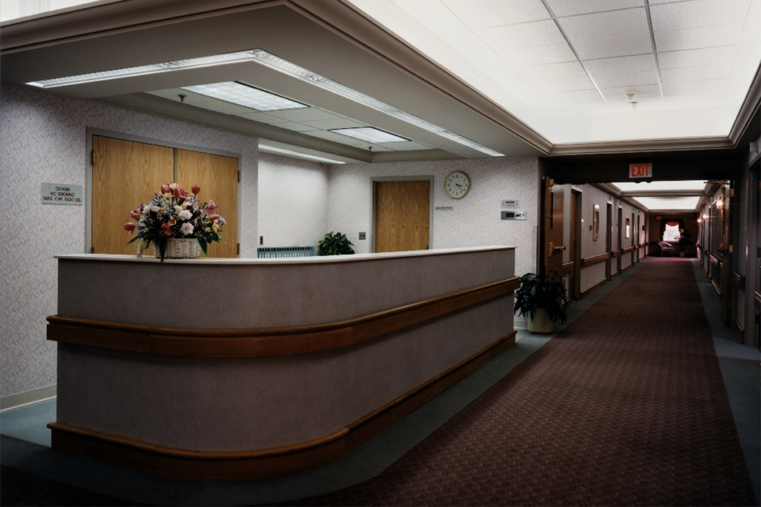 reception desk at care facility, with woman hiding behind desk