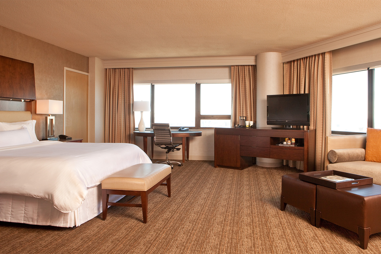 hotel bedroom with a king sized couch and three walls 