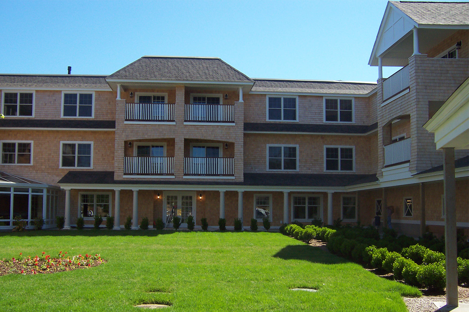 view of side exterior seen from across green lawn 