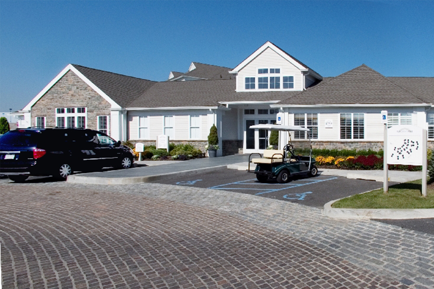 streetview of the Roosevelt Center with a black van parked in the front