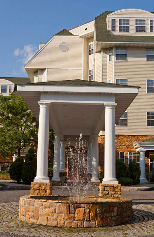 outdoor water fountain in front of Fountain at Rivervue lliving facility