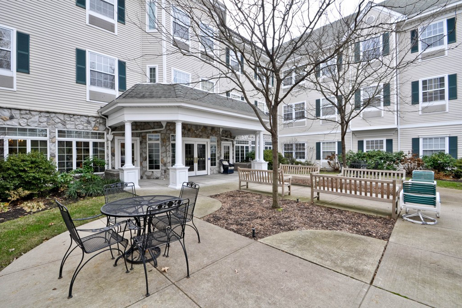 view of black chairs and table outside of Spring Meadows senior living facility
