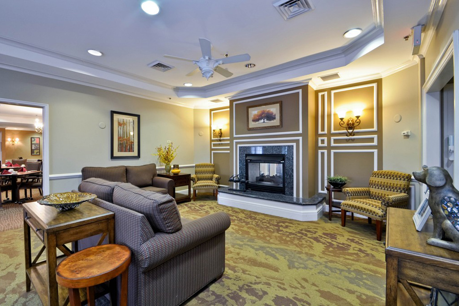 Lounge area with grey leather couch in front of fireplace