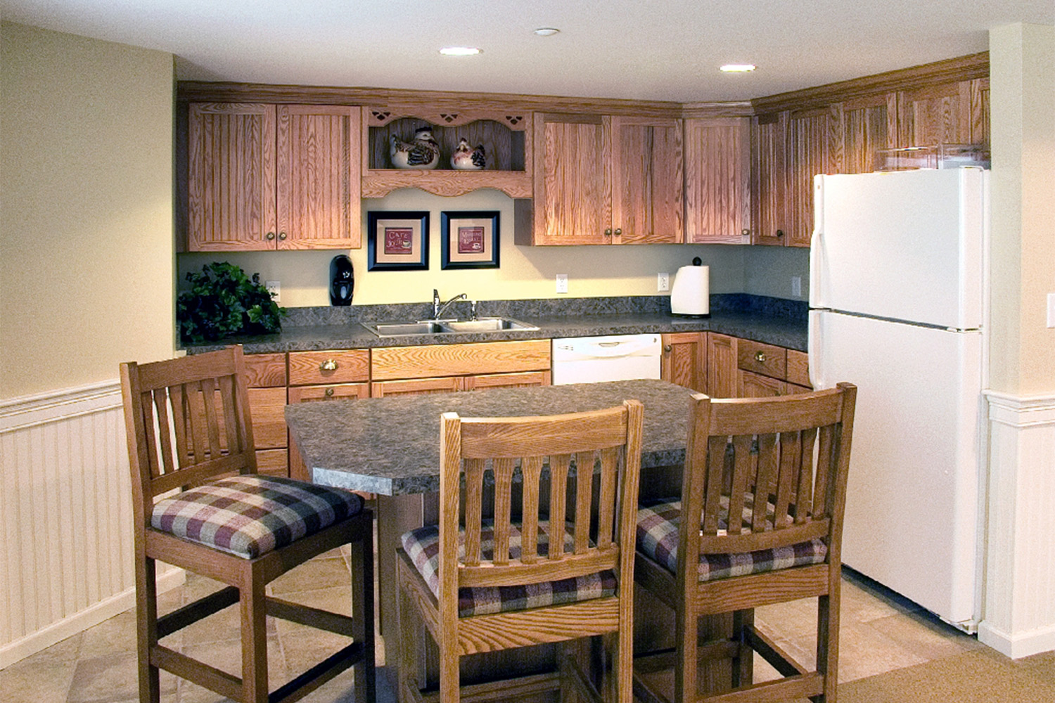 kitchen and dining area with wooden cabinets and white refrigerator 