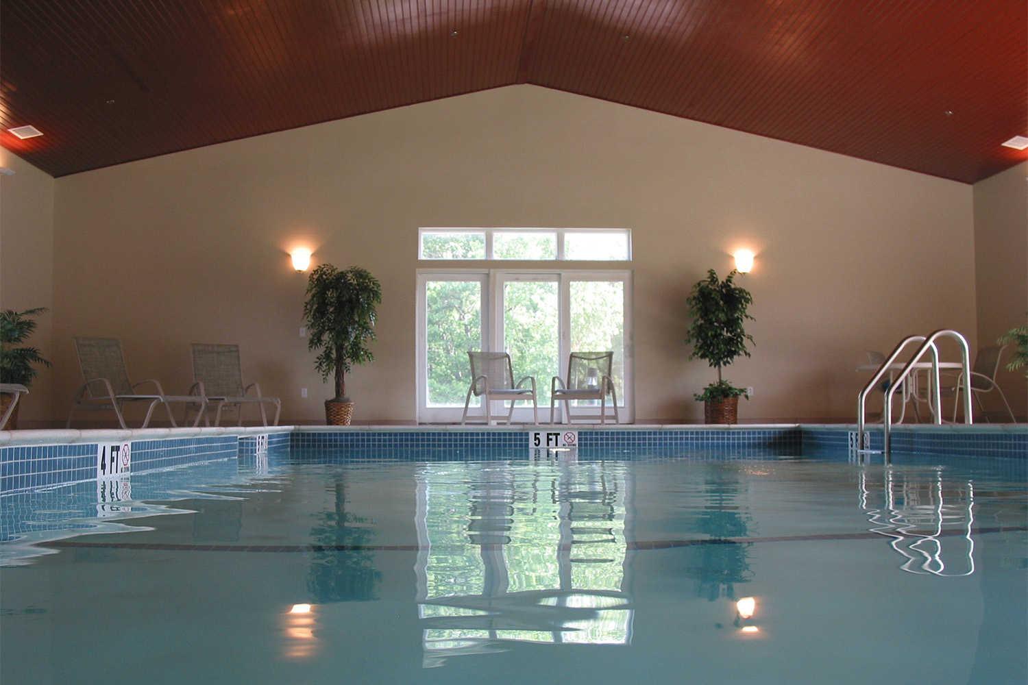 indoor pool area with wooden ceiling 