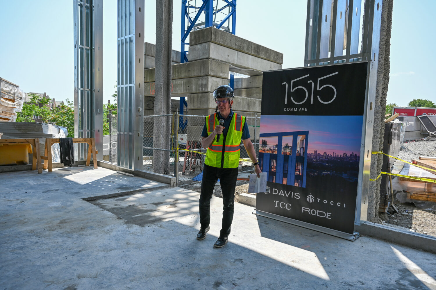 John Tocci speaking to audience during topping off ceremony 