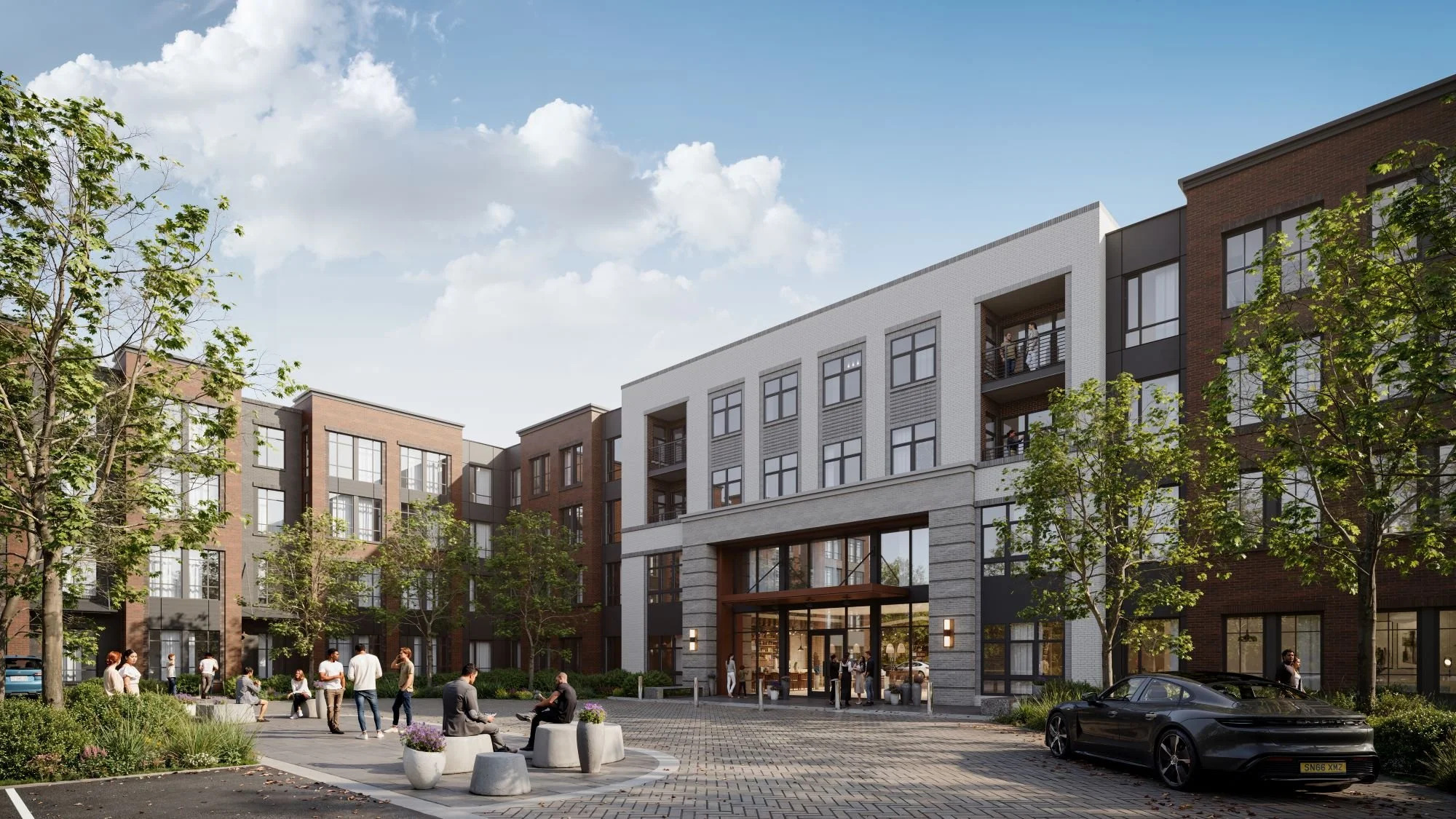 Rendering of the Residences at South Shore, a multi-story brick apartment building with a covered entrance archway, landscaped courtyard seating, and residents socializing outside.
